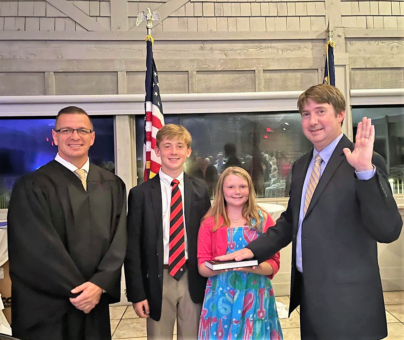 Associate Justice Phil Berger Jr. (left) after swearing in incoming president Clerk Washington (Granville) (right).  Clerk Washington's daughter holds the Bible while his son stands next to her.