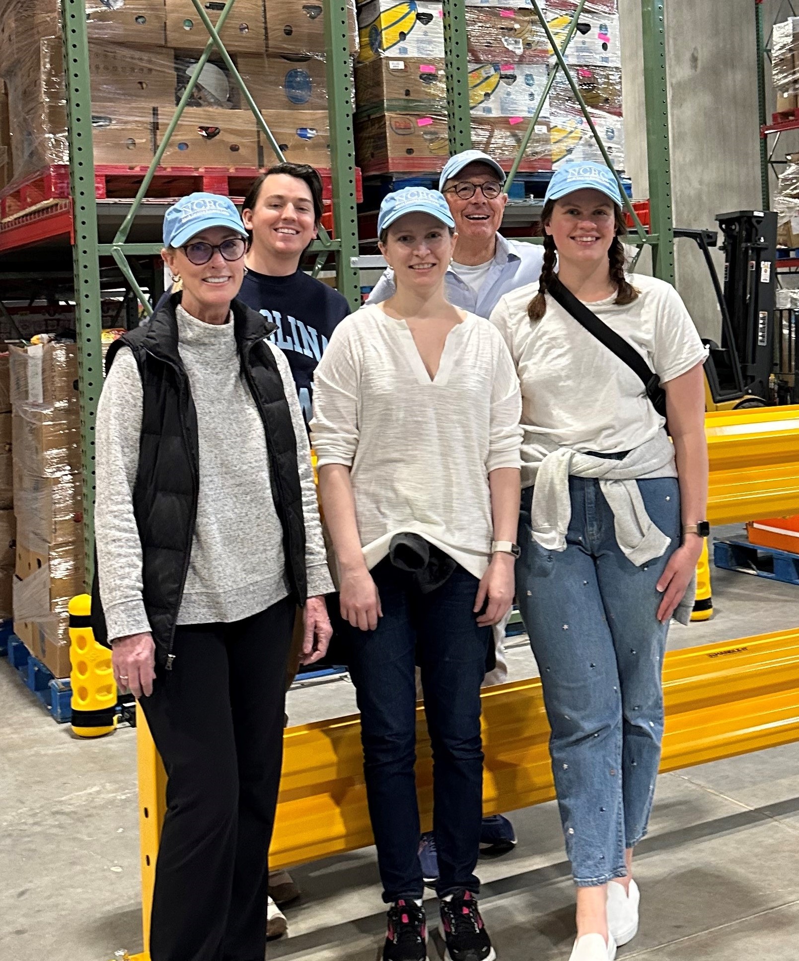 Front row, left to right:  Sharon Turner, Nina  Poe, Sabrina Greer  Back row, left to right: Ryan Dovel (no hat) and Judge Mike Robinson volunteer in the warehouse.