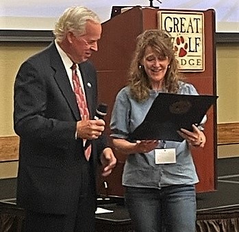 Executive Director of the Chief Justice's Commission on Professionalism (L) presents Jenny Carroll (R) with the Certificate of Excellence Award