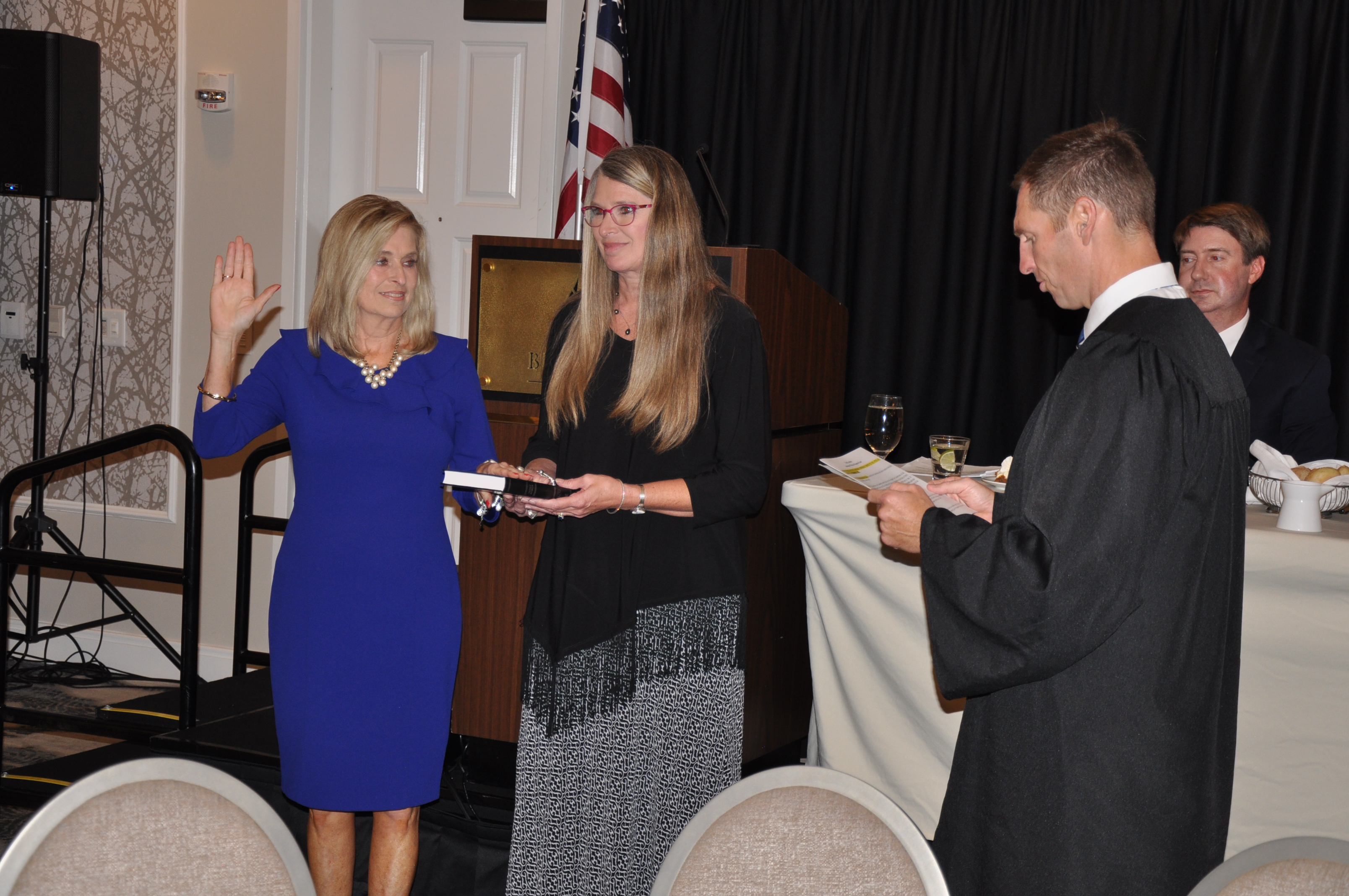 Judge Jefferson Griffin swears in incoming president Catawba County Clerk Kim Sigmon as Lee County Clerk Susie Thomas holds the Bible.