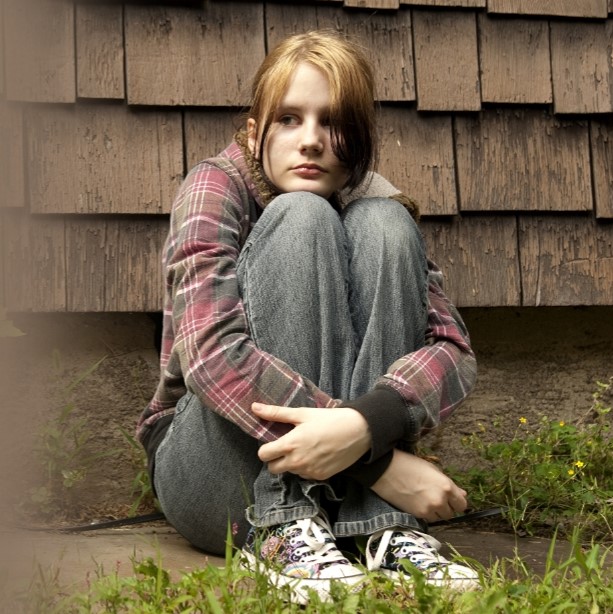 human trafficking minors, a child sitting alone outside