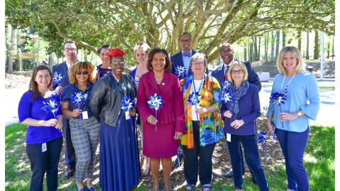 In this photo taken in April, 2019, Chief Justice Cheri Beasley and NCAOC Director McKinley Wooten pose with GAL staff from the state office. 