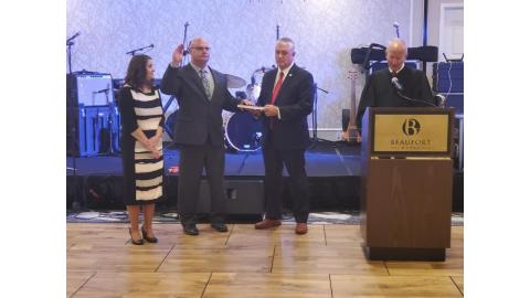 Chief Justice Paul Newby swearing in incoming president Clerk Matusko (Currituck), with Clerk Tilley (Perquimans) holding the bible. Lori Matusko accompanies them.