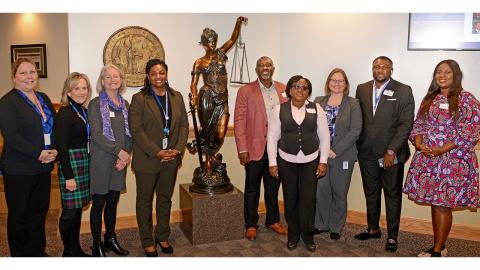 From left to right, NCDRC Administrative Assistants Mary Brooks and Maureen Robinson, DOL REDA Administrator Harriet Hopkins,  Court Management Specialist DeMaca Adams,  Mr. Samuel George Lamptey, Mrs. Nana Oye Nartey NCDRC Executive Director Tara Kozlowski, Mr. Isaac Akomanyi, and Mrs. Reina Koranteng.