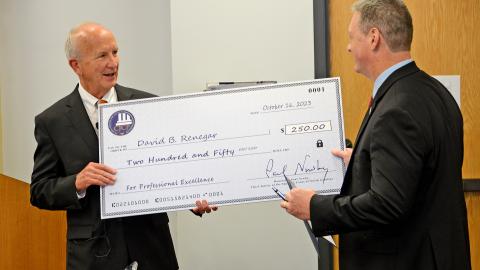 Chief Justice Paul Newby (left) presents NCGAL District Administrator David Renegar (right) with the 2023 Courthouse Employee of they Year Award Chief Justice Paul Newby (left) presents NCGAL District Administrator David Renegar (right) with the 2023 Courthouse Employee of they Year Award